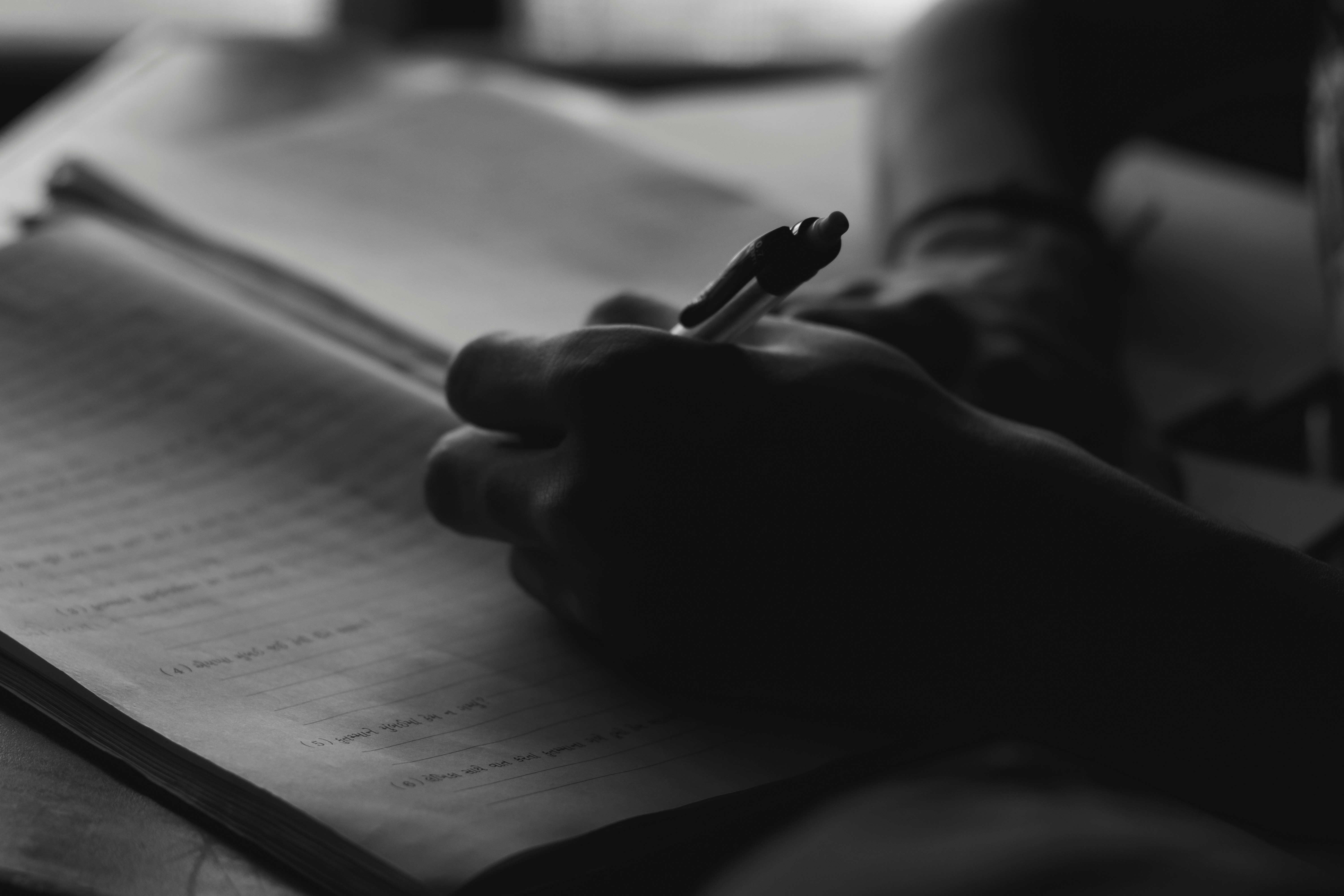 An author writing in a notebook